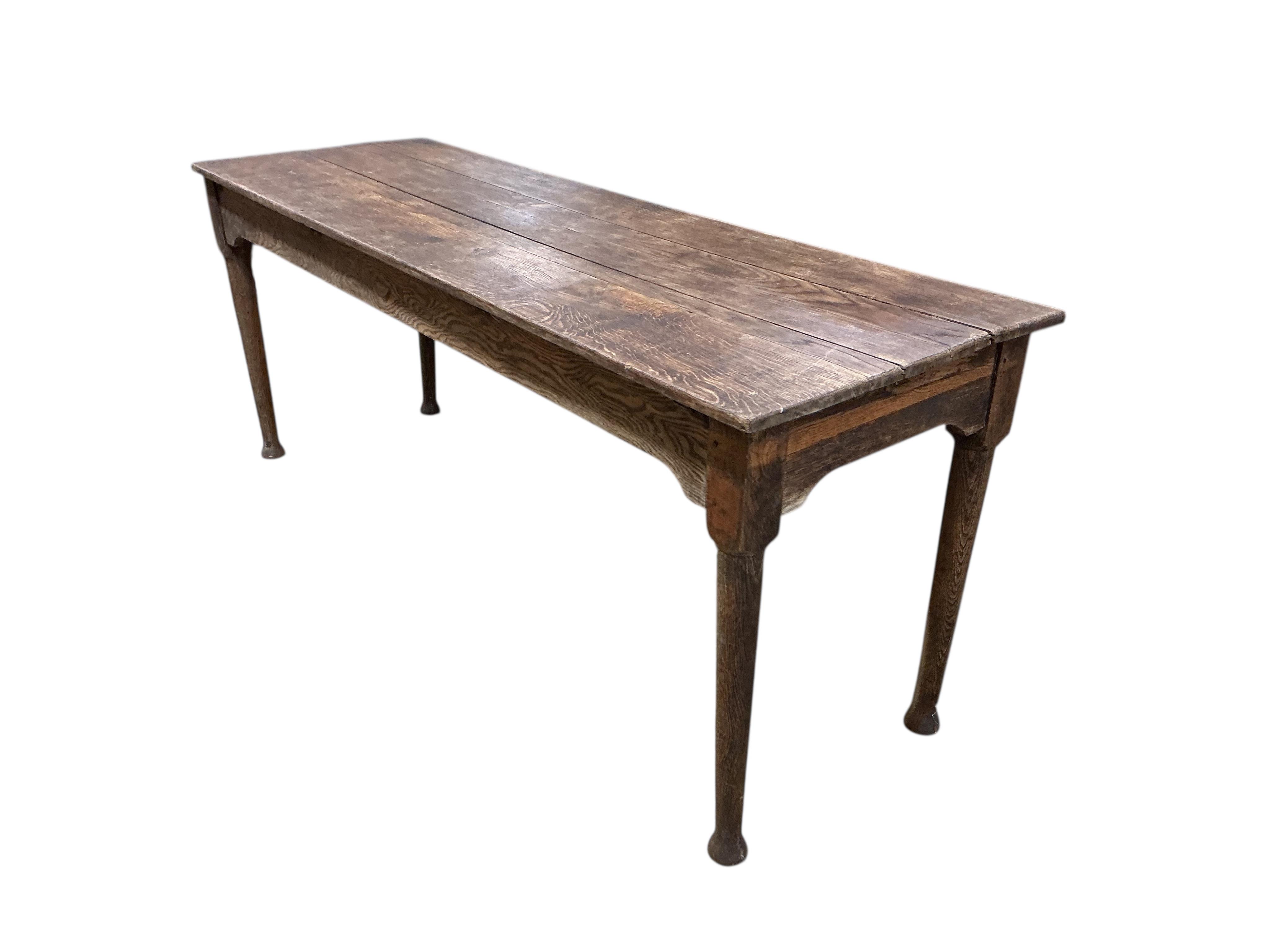 A 19th century rectangular oak plank topped dining table, width 183cm, depth 60cm, height 73cm